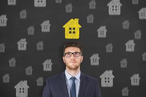 Businessman thinking of property insurance